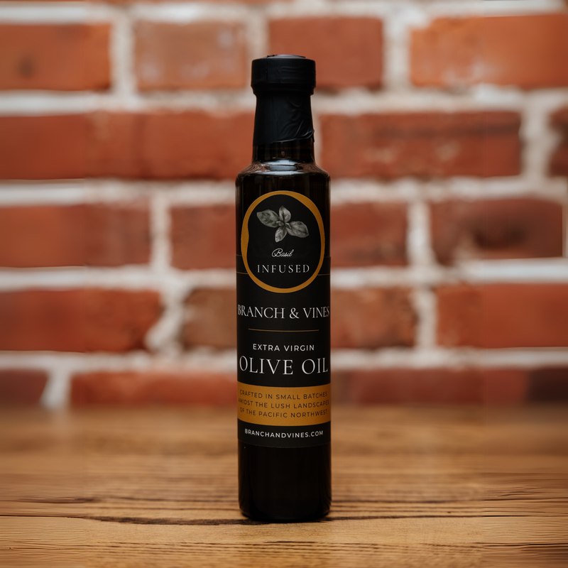 Fresh Basil Infused Olive Oil bottle against a rustic brick backdrop.