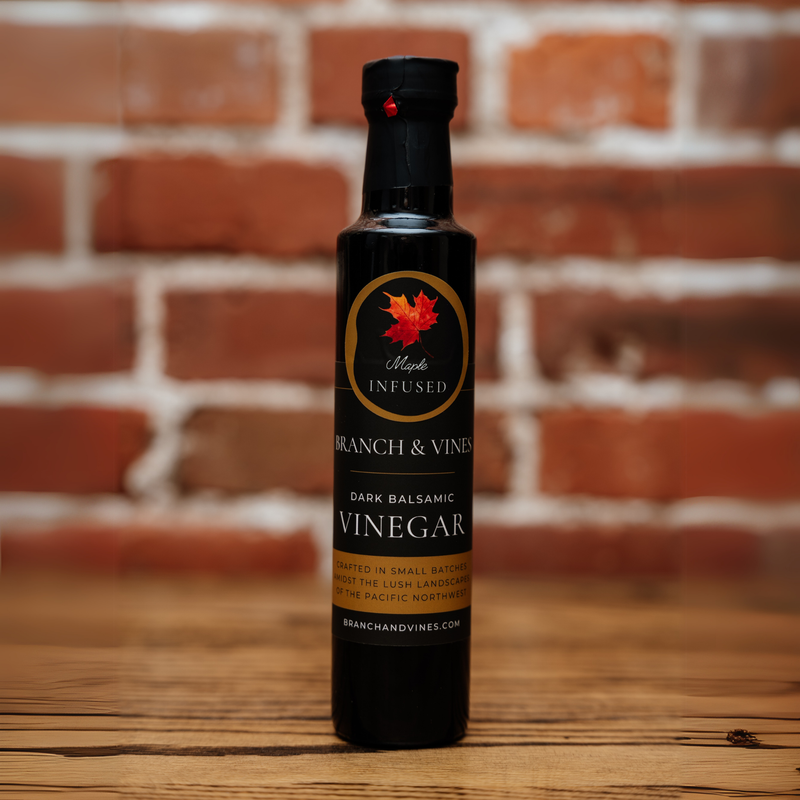 Maple Dark Balsamic Vinegar bottle against a rustic brick backdrop.