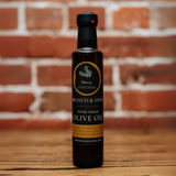 Rosemary Infused Olive Oil bottle against a rustic brick backdrop.