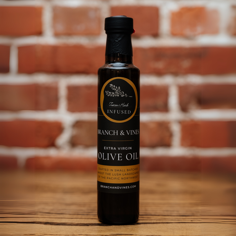 Tuscan Herb Infused Olive Oil bottle against a rustic brick backdrop.