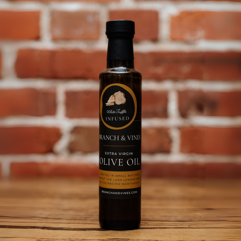 White Truffle Infused Olive Oil bottle against a rustic brick backdrop.